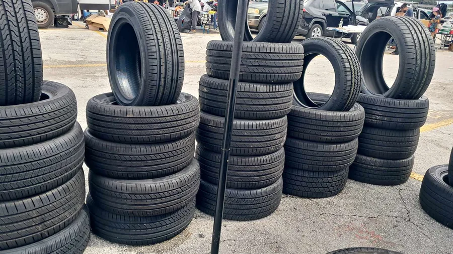 Stacks of new and used tires ready to mount - Fredoo Mobile Tire Shop, Fort Lauderdale, FL