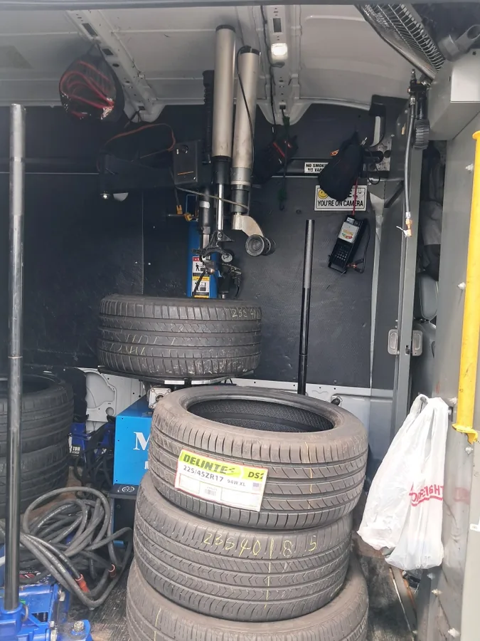 Tire machine and tires inside the Fredoo Mobile Tire Shop van